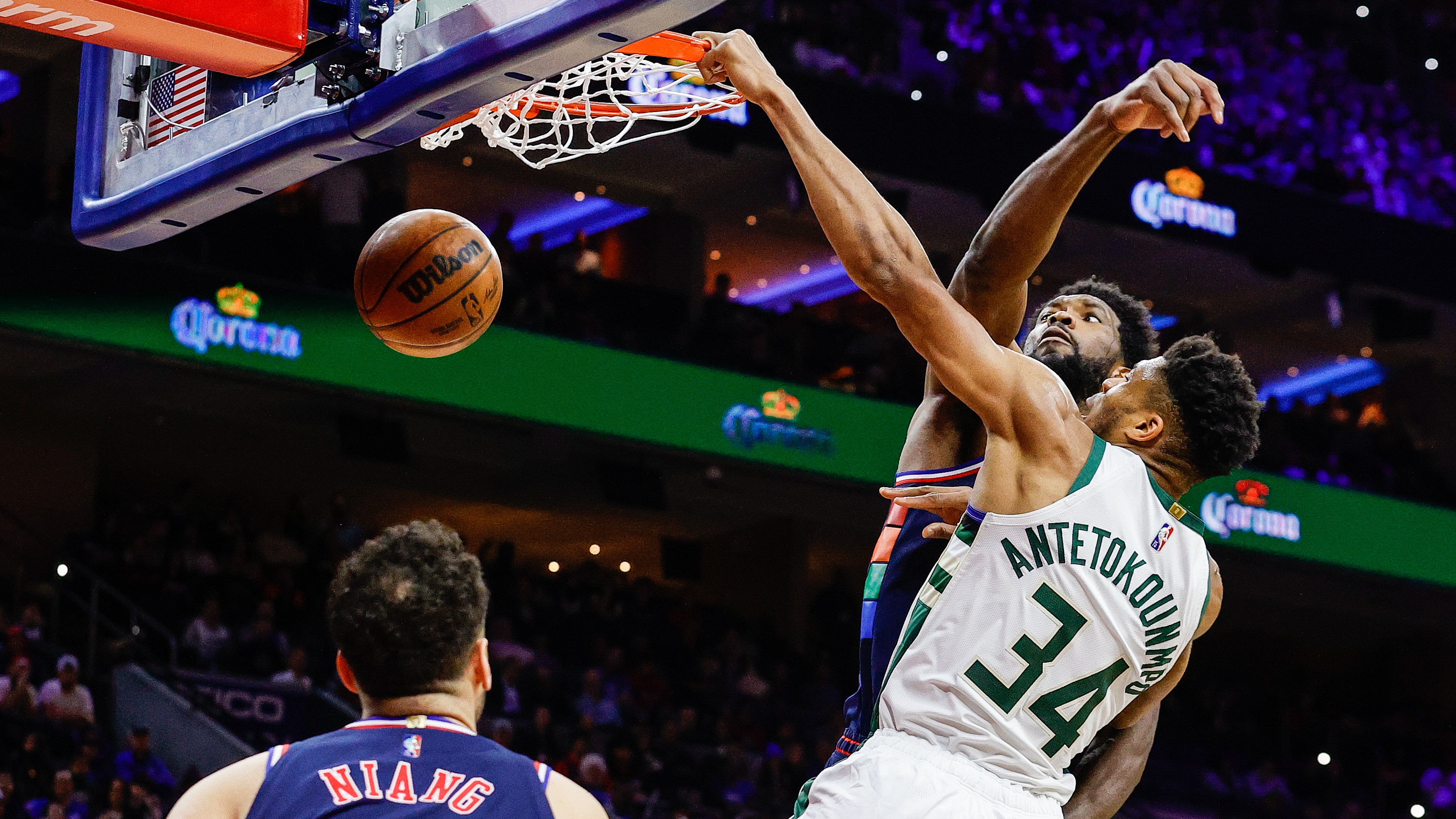 Slideshow-image: Joel Embiid #21 of the Philadelphia 76ers guards as Giannis Antetokounmpo #34 of the Milwaukee Bucks dunks during the first quarter at Wells Fargo ...